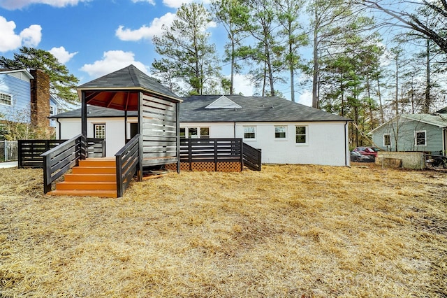 rear view of house featuring a deck