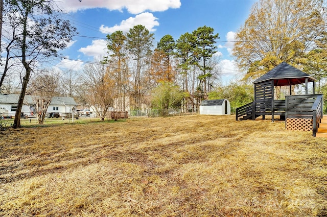 view of yard with a storage unit and a deck