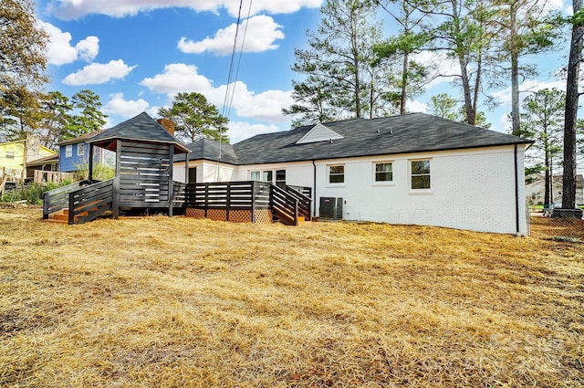 rear view of property with central AC and a wooden deck