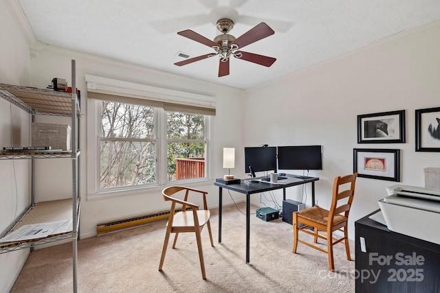 carpeted office space with crown molding, ceiling fan, and a baseboard heating unit