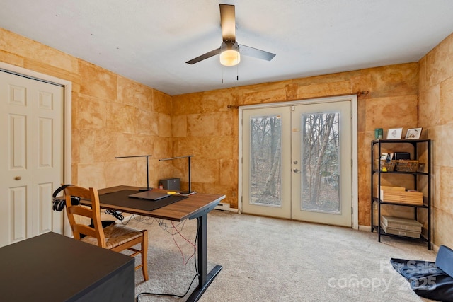 carpeted office featuring french doors and ceiling fan