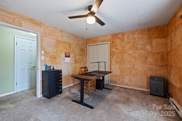 home office featuring baseboard heating, ceiling fan, and carpet flooring