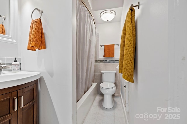 full bathroom featuring vanity, shower / bath combo, tile patterned floors, and toilet