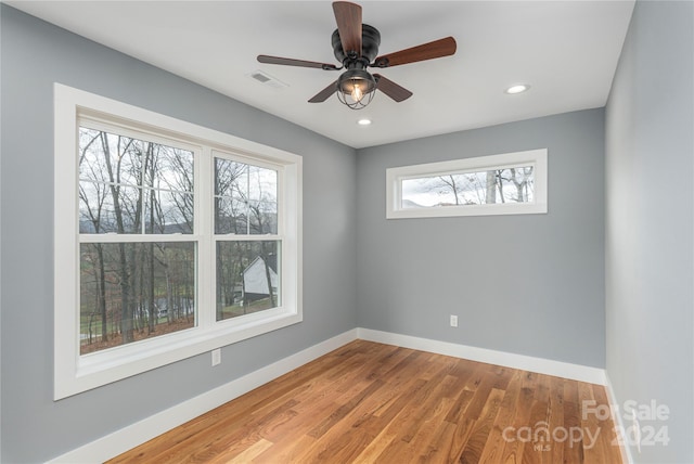 empty room with hardwood / wood-style flooring and ceiling fan