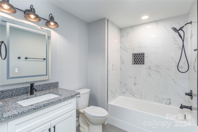 full bathroom featuring tile patterned flooring, vanity, toilet, and tiled shower / bath