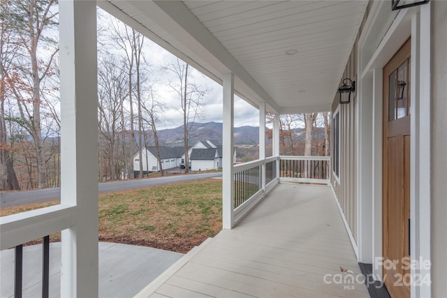 sunroom with a mountain view and a wealth of natural light