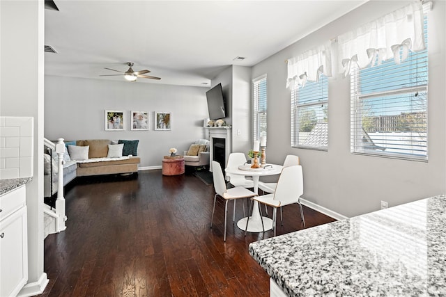 dining area featuring dark hardwood / wood-style floors and ceiling fan