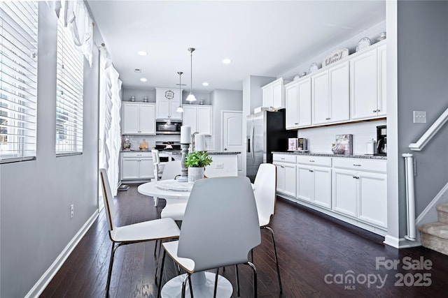 dining area featuring dark wood-type flooring