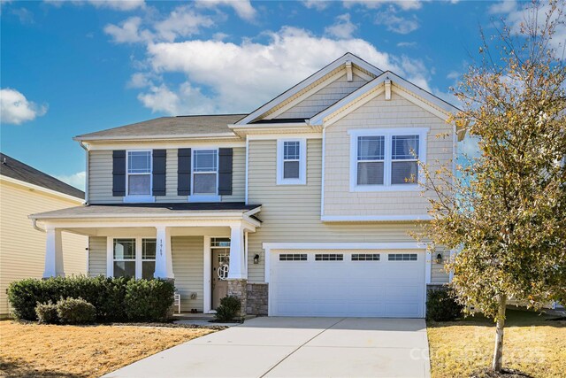 craftsman inspired home with a garage and a porch