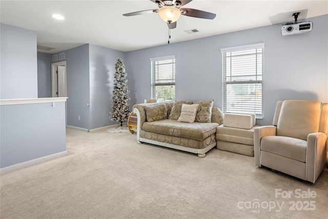 carpeted living room featuring ceiling fan