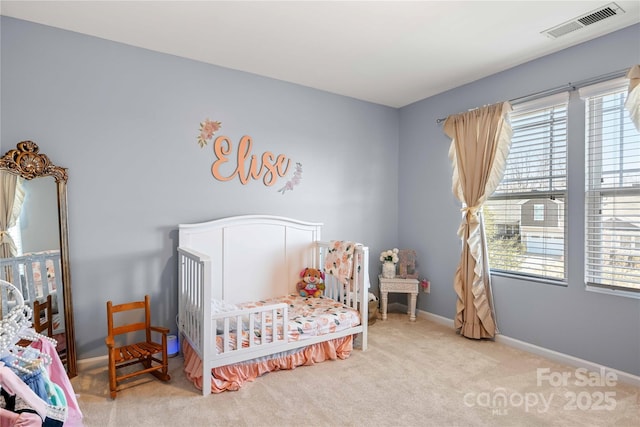 carpeted bedroom with a crib