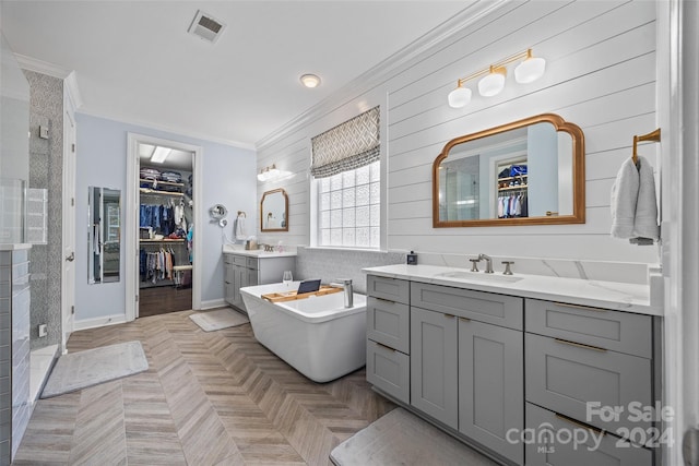 bathroom with separate shower and tub, vanity, parquet floors, and ornamental molding