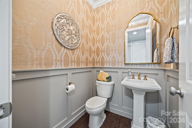 bathroom featuring hardwood / wood-style floors, toilet, ornamental molding, and sink