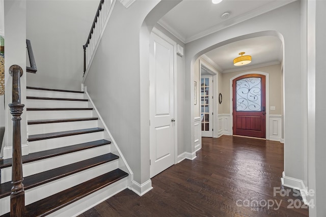 entrance foyer featuring dark wood-type flooring and ornamental molding