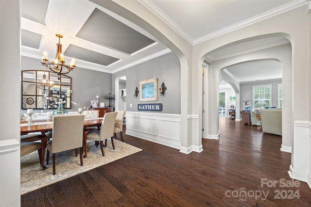 dining space with ornamental molding, dark wood-type flooring, and an inviting chandelier