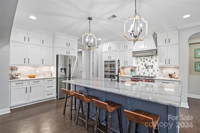 kitchen featuring white cabinets, a center island with sink, custom range hood, and stainless steel appliances