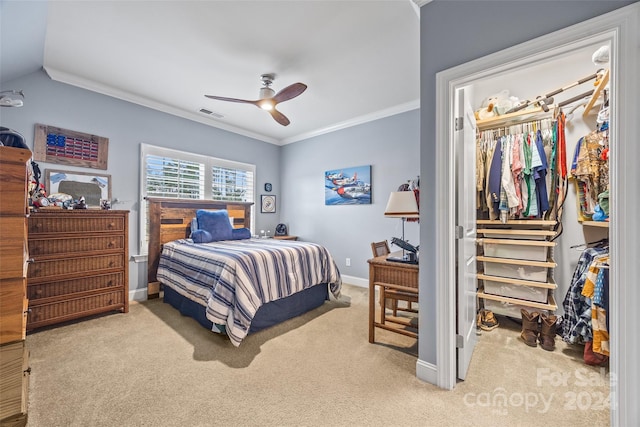 bedroom featuring carpet, ceiling fan, ornamental molding, and a closet