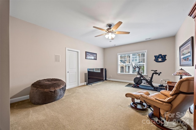 living area with carpet flooring and ceiling fan