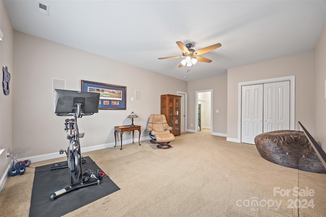 workout room featuring ceiling fan and carpet floors