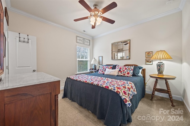 carpeted bedroom with ceiling fan and ornamental molding