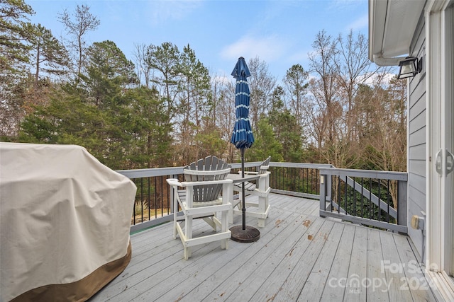 wooden deck featuring area for grilling