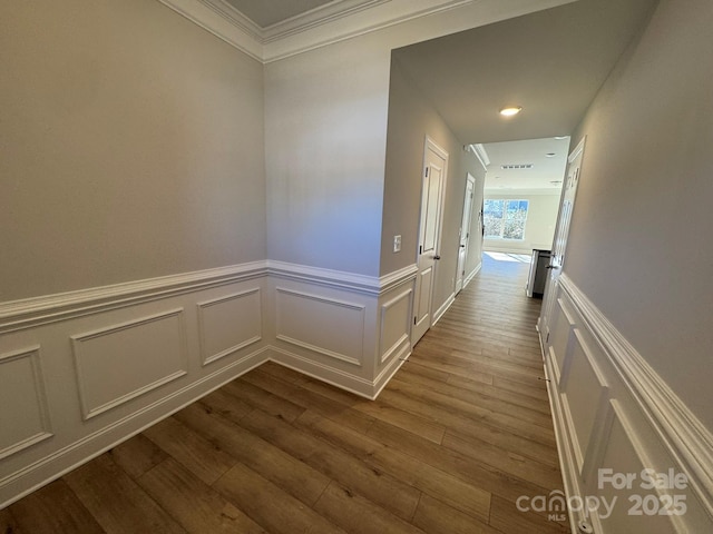 hallway featuring hardwood / wood-style flooring and ornamental molding