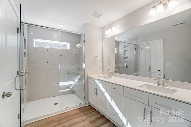 bathroom featuring vanity, a shower with door, and hardwood / wood-style floors