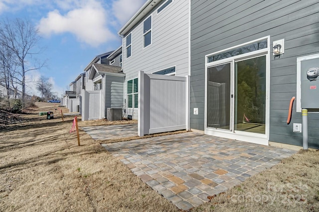 exterior space featuring a lawn, central AC, and a patio