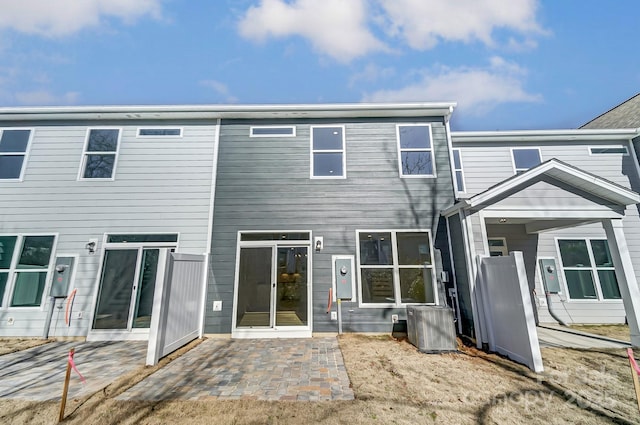 rear view of house with a patio area and central AC