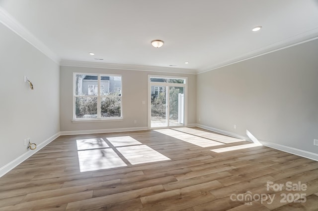 unfurnished room featuring ornamental molding and light hardwood / wood-style floors