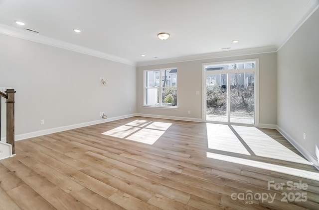 interior space with ornamental molding and light hardwood / wood-style flooring