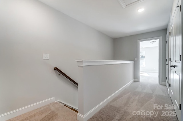 corridor featuring light colored carpet