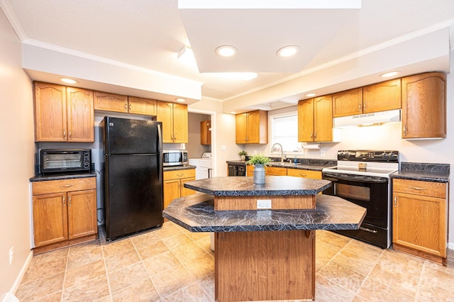 kitchen with black refrigerator, sink, white electric stove, separate washer and dryer, and a kitchen island