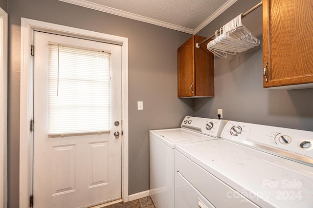 washroom with cabinets, tile patterned floors, crown molding, a textured ceiling, and washer and clothes dryer