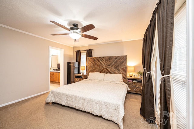 carpeted bedroom with a textured ceiling, ensuite bathroom, ceiling fan, and crown molding