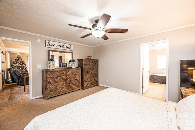 carpeted bedroom with a textured ceiling, ceiling fan, crown molding, and ensuite bathroom