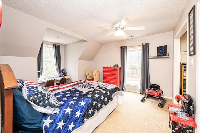 carpeted bedroom featuring multiple windows, ceiling fan, and a textured ceiling