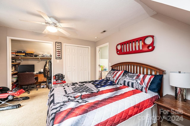 carpeted bedroom with ceiling fan and a textured ceiling