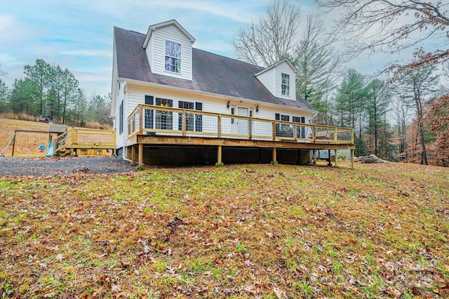rear view of property featuring a wooden deck