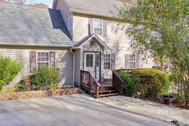 view of front of property featuring a patio and a wooden deck