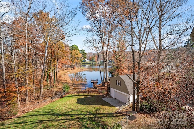 view of yard with a water view and a dock