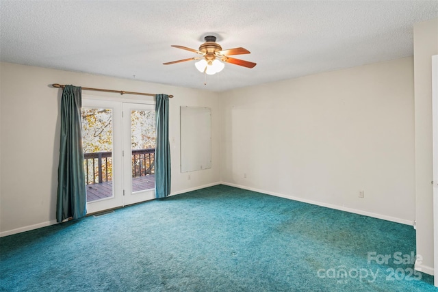 carpeted empty room featuring ceiling fan and a textured ceiling