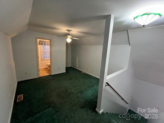 bonus room with ceiling fan, lofted ceiling, and dark colored carpet