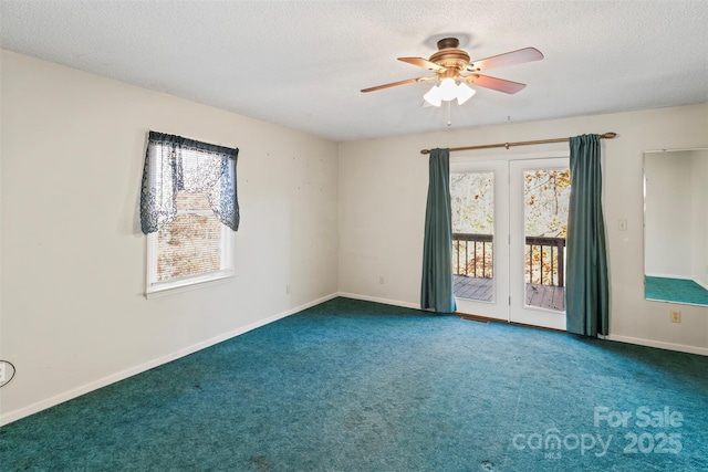 carpeted spare room with a textured ceiling and ceiling fan