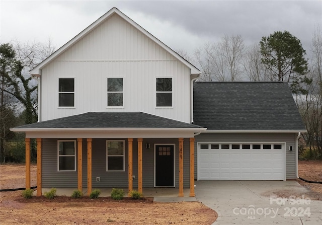 view of front of home featuring a porch and a garage