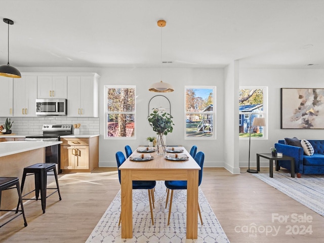 dining space featuring light wood-type flooring