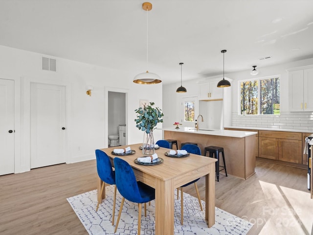 dining area featuring light hardwood / wood-style floors and sink