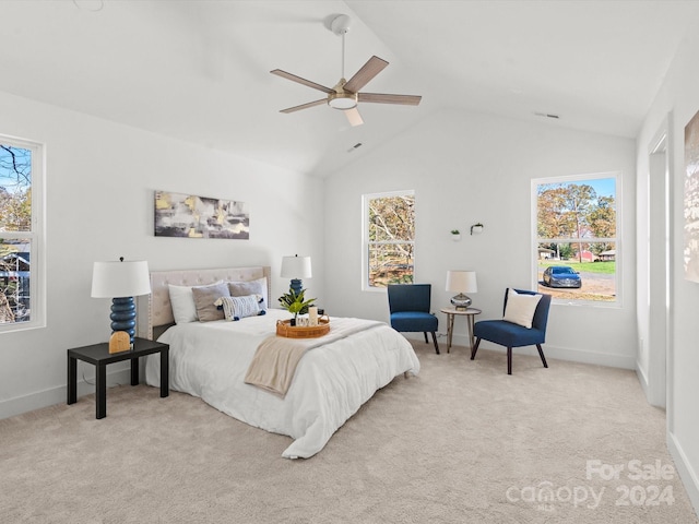 bedroom with multiple windows, ceiling fan, light carpet, and lofted ceiling