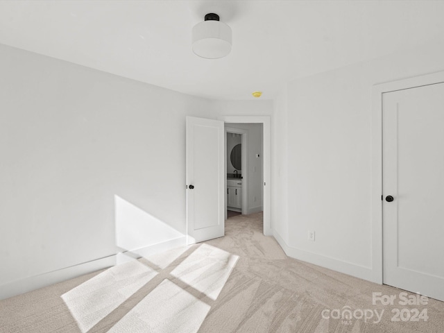 unfurnished bedroom featuring light colored carpet