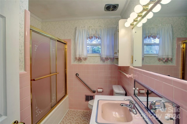 full bathroom with enclosed tub / shower combo, toilet, a healthy amount of sunlight, and sink